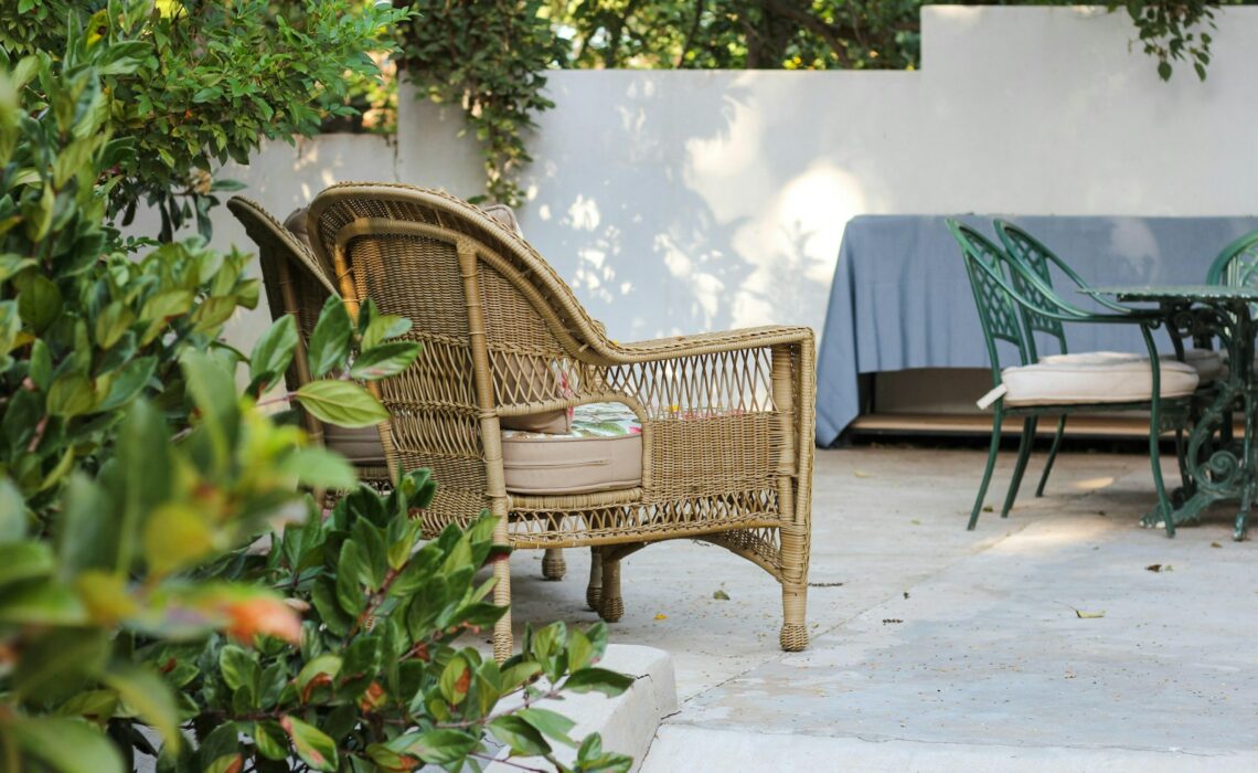 brown wooden armchair beside green plant
